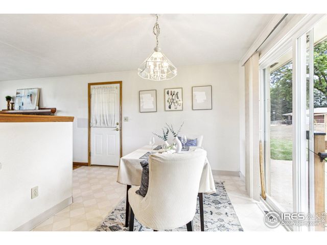 a living room with hard wood flooring and a chandelier
