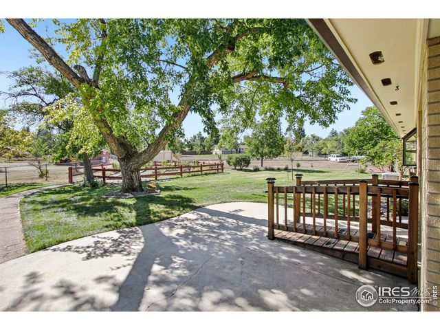 a view of a porch with wooden floor and fence