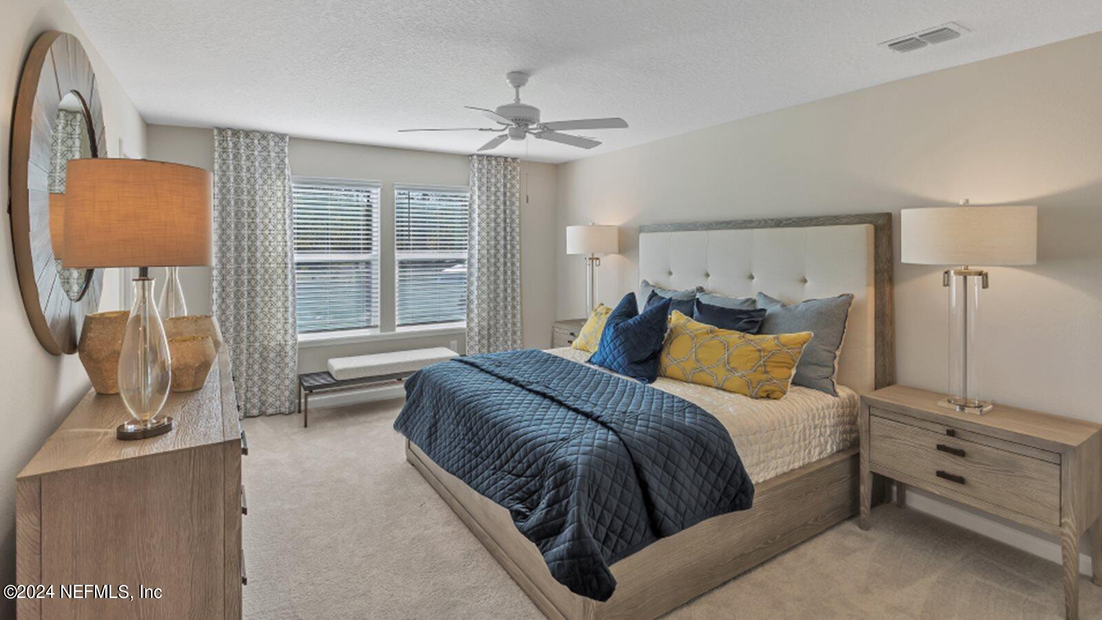 4338 Leeward Breeze Loop Middleburg, FL 32068 - Photo 12 of 13 a bedroom with a large bed and a flat tv screen on dresser