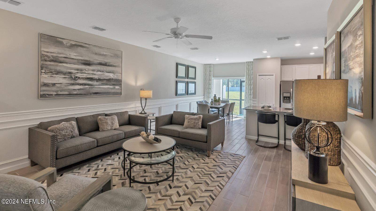 4338 Leeward Breeze Loop Middleburg, FL 32068 - Photo 5 of 13 a living room with furniture and a large window