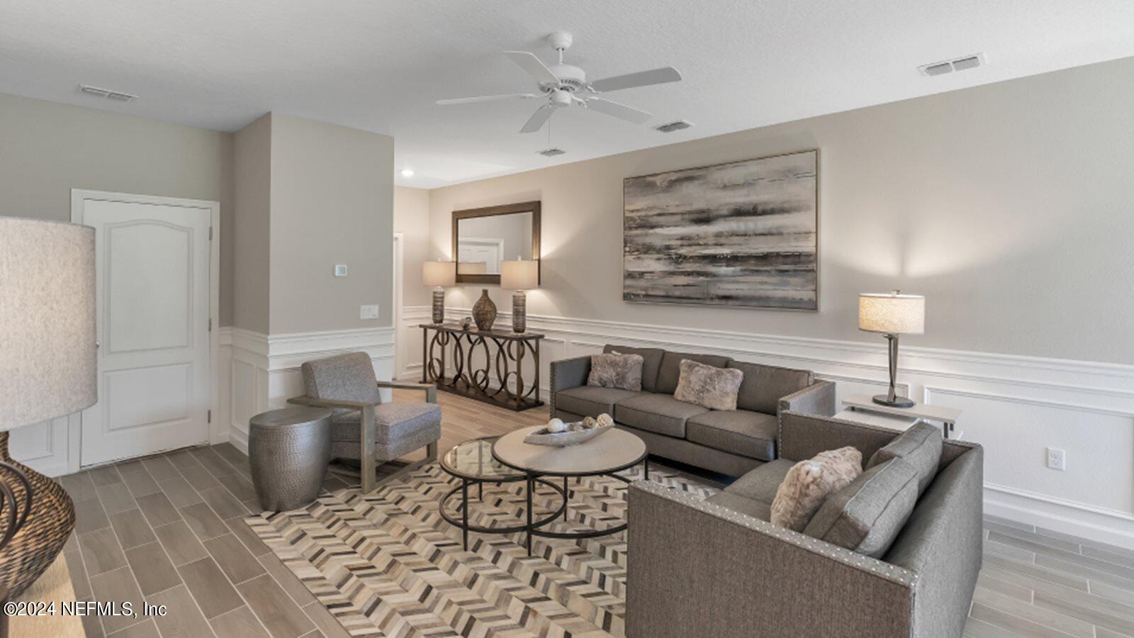 4338 Leeward Breeze Loop Middleburg, FL 32068 - Photo 6 of 13 a living room with furniture and wooden floor