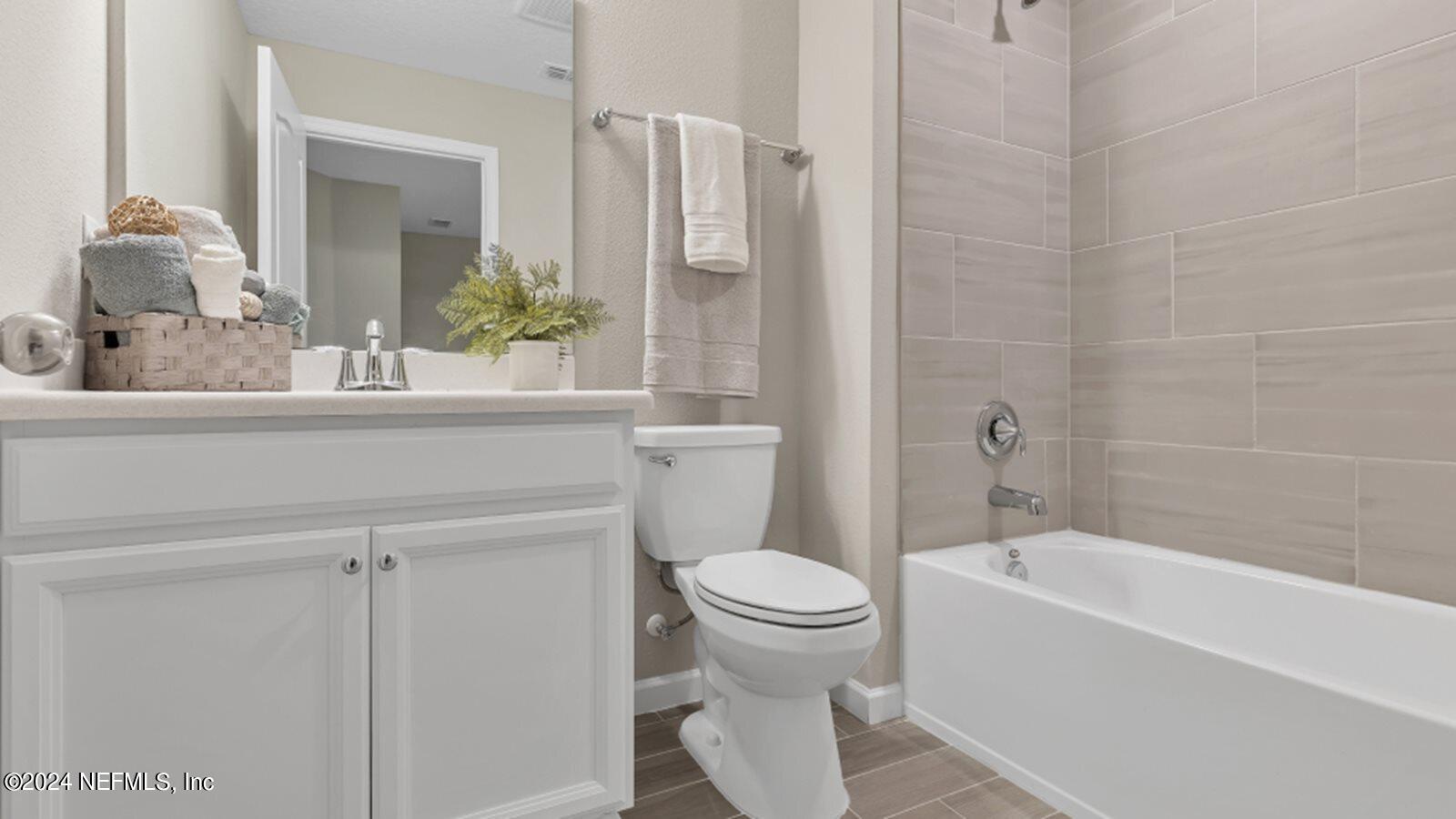 4338 Leeward Breeze Loop Middleburg, FL 32068 - Photo 7 of 13 a bathroom with a sink a toilet and shower