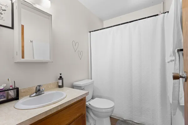a bathroom with a sink toilet and mirror
