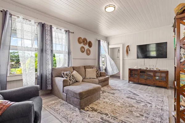 a living room with furniture and a flat screen tv