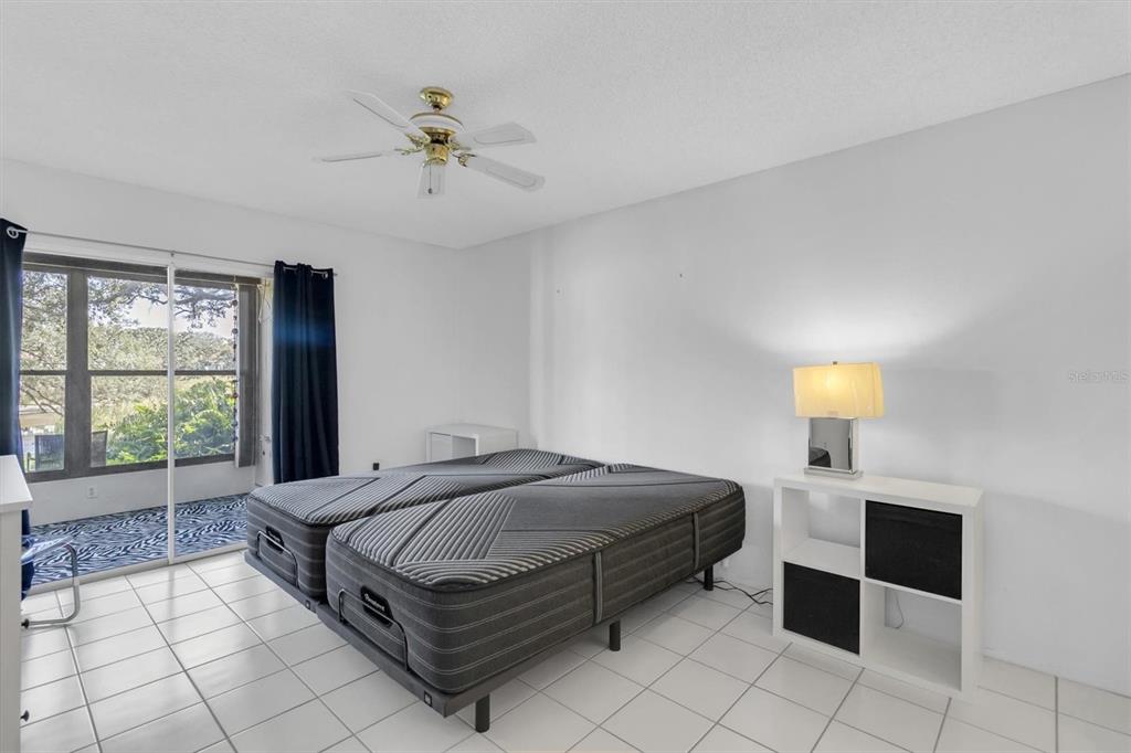 11410 Carriage Hill Drive, Unit 1 Port Richey, FL 34668 - Photo 12 of 63 a spacious bedroom with a bed and window