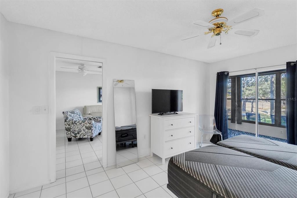 11410 Carriage Hill Drive, Unit 1 Port Richey, FL 34668 - Photo 13 of 63 a bedroom with a bed and a television