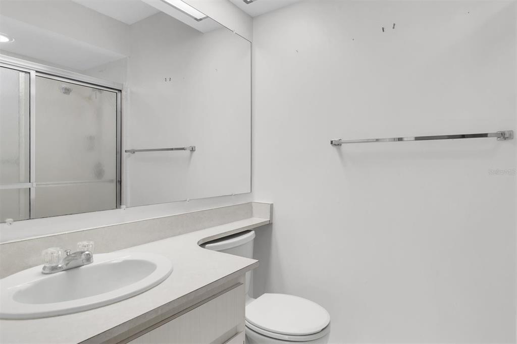 11410 Carriage Hill Drive, Unit 1 Port Richey, FL 34668 - Photo 16 of 63 a bathroom with a sink toilet and shower