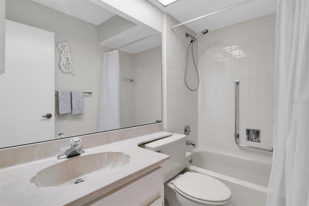 11410 Carriage Hill Drive, Unit 1 Port Richey, FL 34668 - Photo 20 of 63 a bathroom with a sink toilet tub and shower
