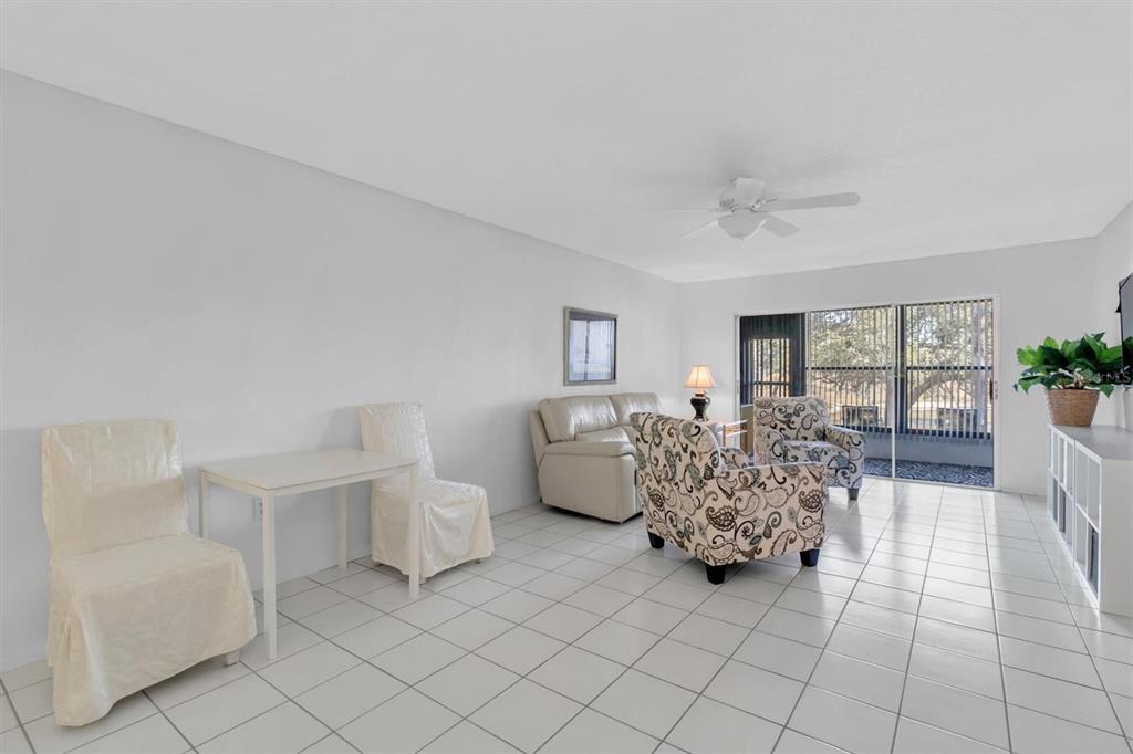 11410 Carriage Hill Drive, Unit 1 Port Richey, FL 34668 - Photo 2 of 63 a bed room with furniture and wooden floor