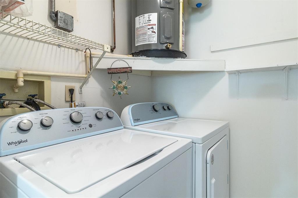 11410 Carriage Hill Drive, Unit 1 Port Richey, FL 34668 - Photo 22 of 63 a utility room with dryer and washer