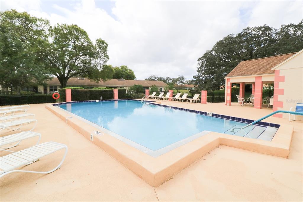 11410 Carriage Hill Drive, Unit 1 Port Richey, FL 34668 - Photo 40 of 63 a view of a house with swimming pool and sitting area