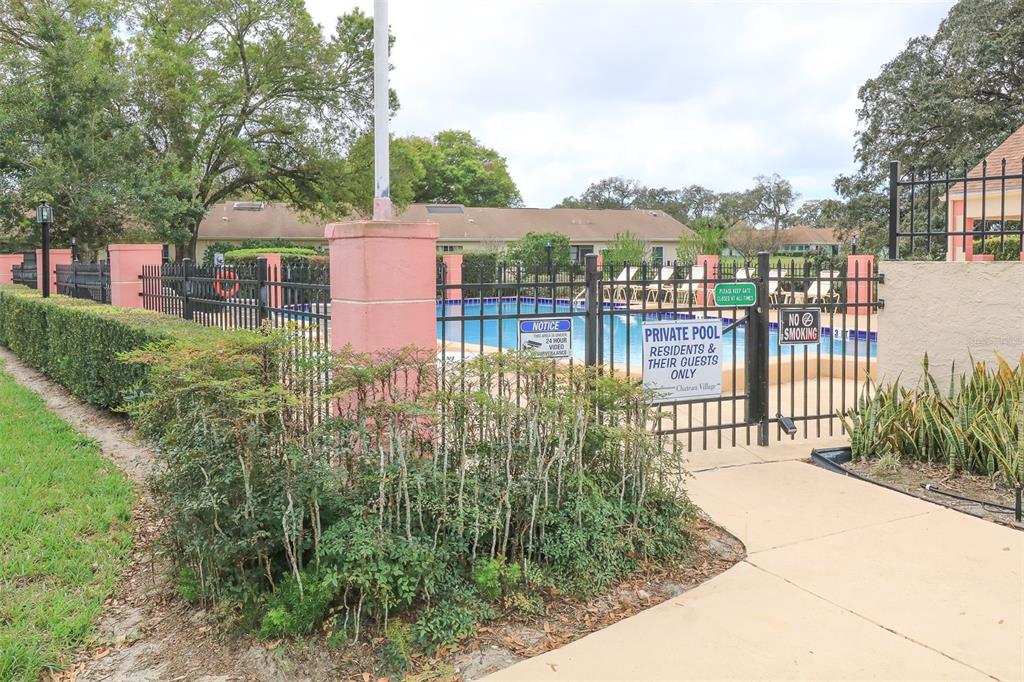 11410 Carriage Hill Drive, Unit 1 Port Richey, FL 34668 - Photo 42 of 63 a view of a houses with a yard and plants