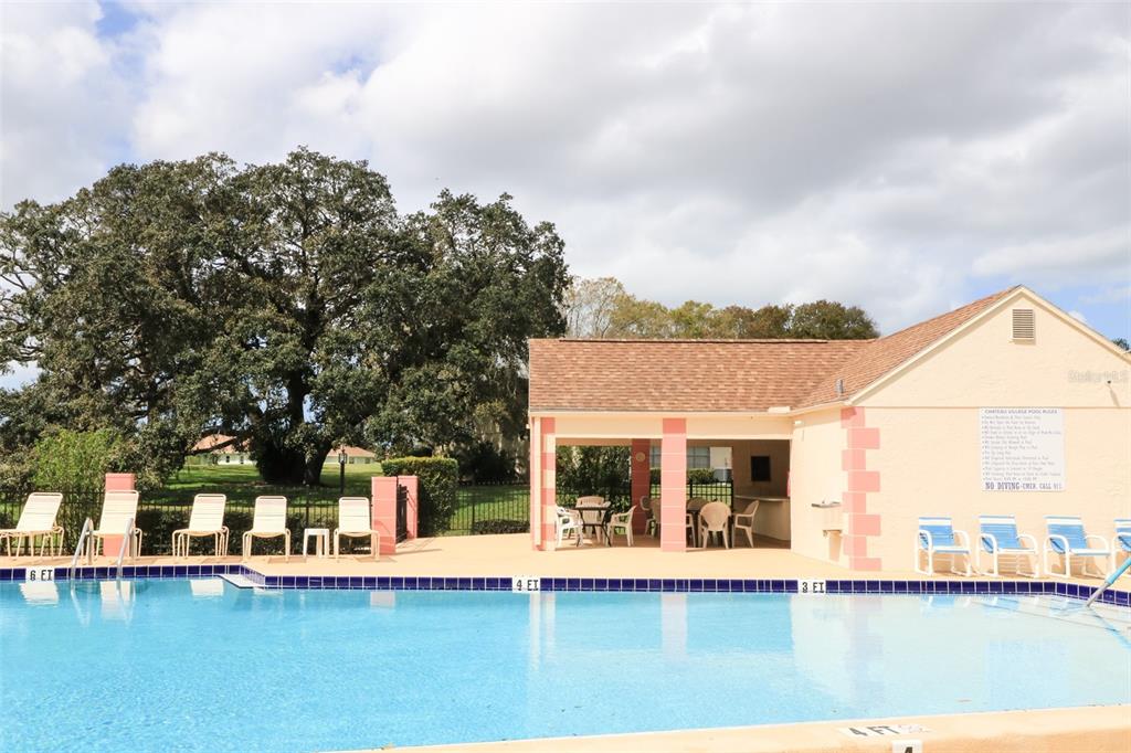 11410 Carriage Hill Drive, Unit 1 Port Richey, FL 34668 - Photo 45 of 63 a front view of a house with a yard