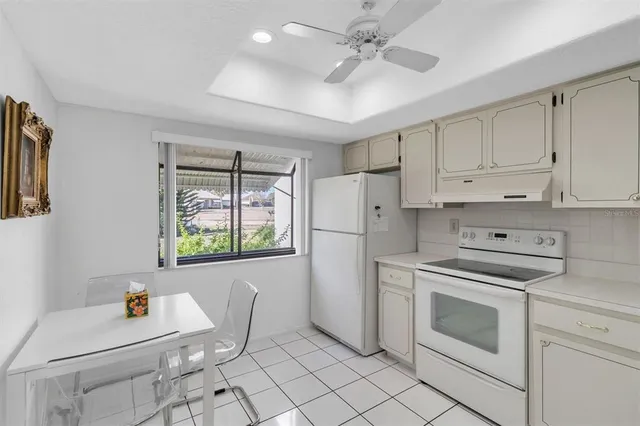 a kitchen with white cabinets and white appliances