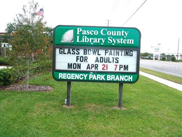 11410 Carriage Hill Drive, Unit 1 Port Richey, FL 34668 - Photo 63 of 63 a sign on the side of the road