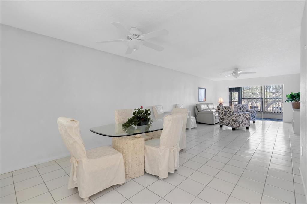 11410 Carriage Hill Drive, Unit 1 Port Richey, FL 34668 - Photo 9 of 63 a living room with furniture and a table