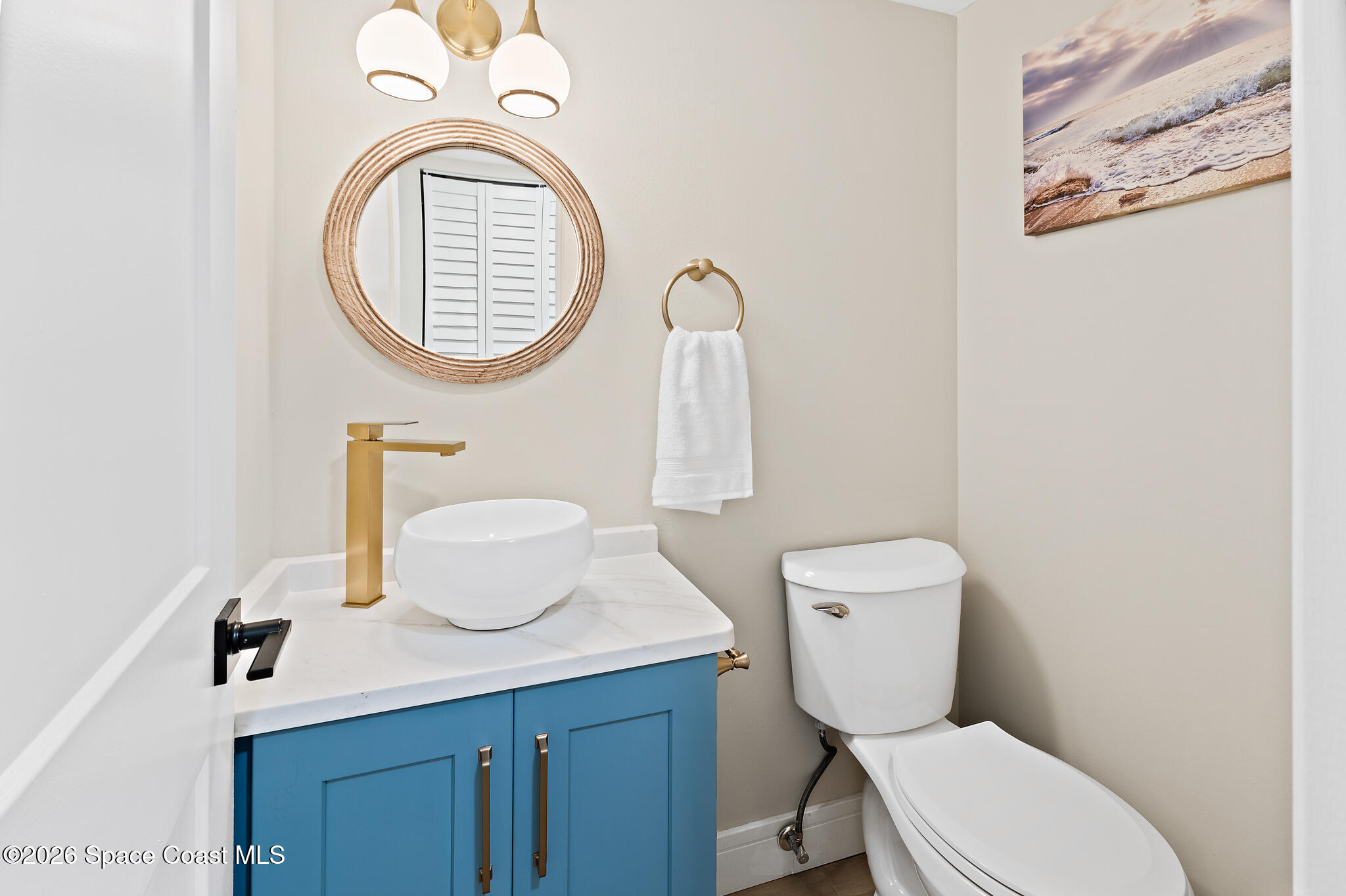 150 Intrepid Way, Unit 8D Cape Canaveral, FL 32920 - Photo 15 of 36 a bathroom with a toilet a sink and a mirror