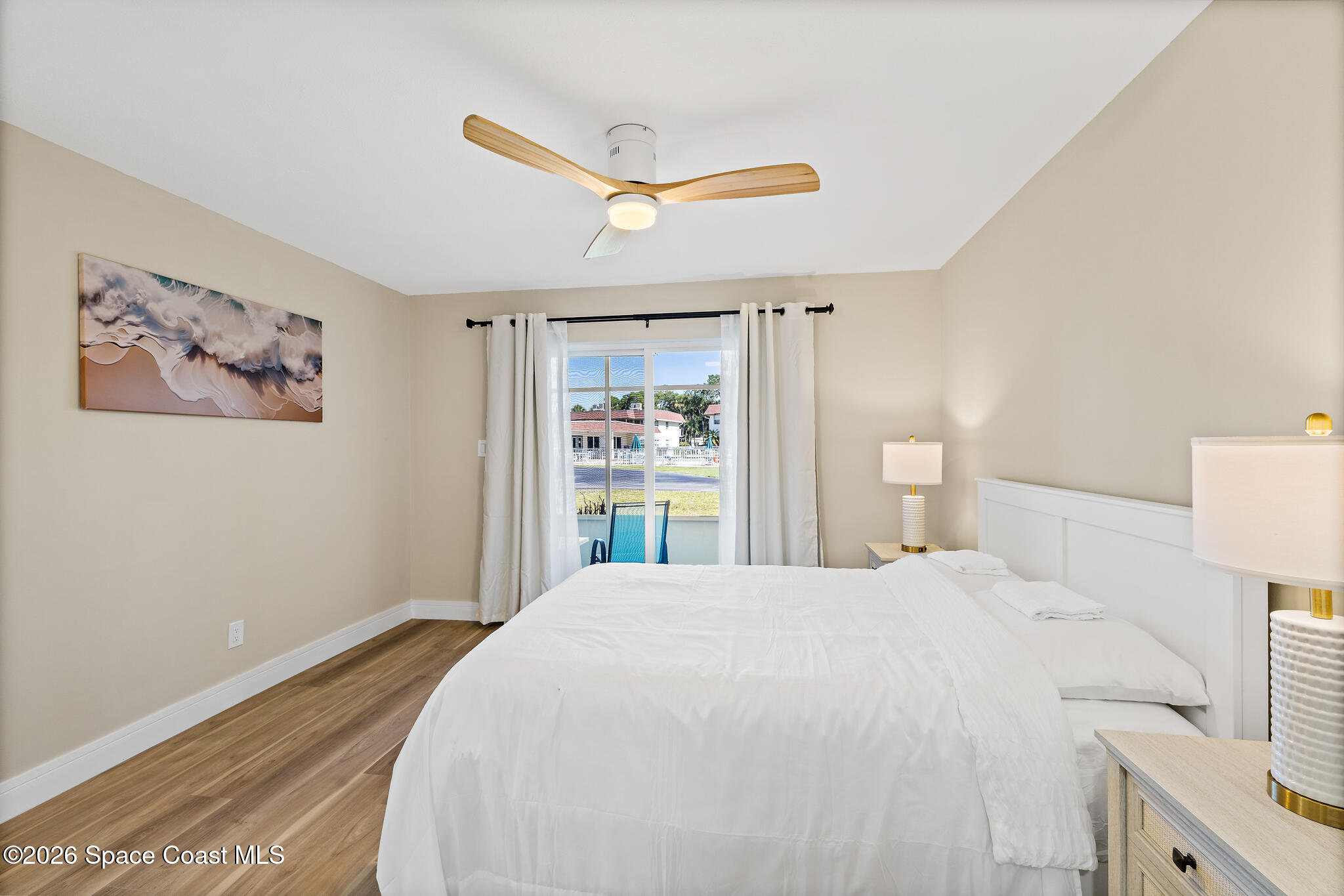 150 Intrepid Way, Unit 8D Cape Canaveral, FL 32920 - Photo 16 of 36 a bedroom with a large bed and a window
