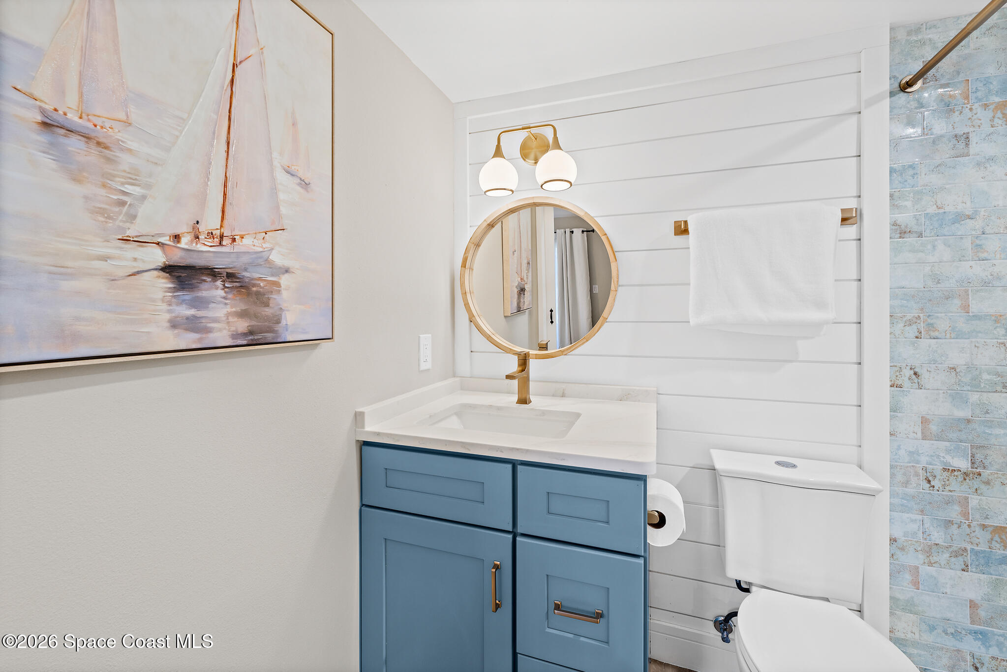 150 Intrepid Way, Unit 8D Cape Canaveral, FL 32920 - Photo 20 of 36 a bathroom with a sink a toilet and a mirror