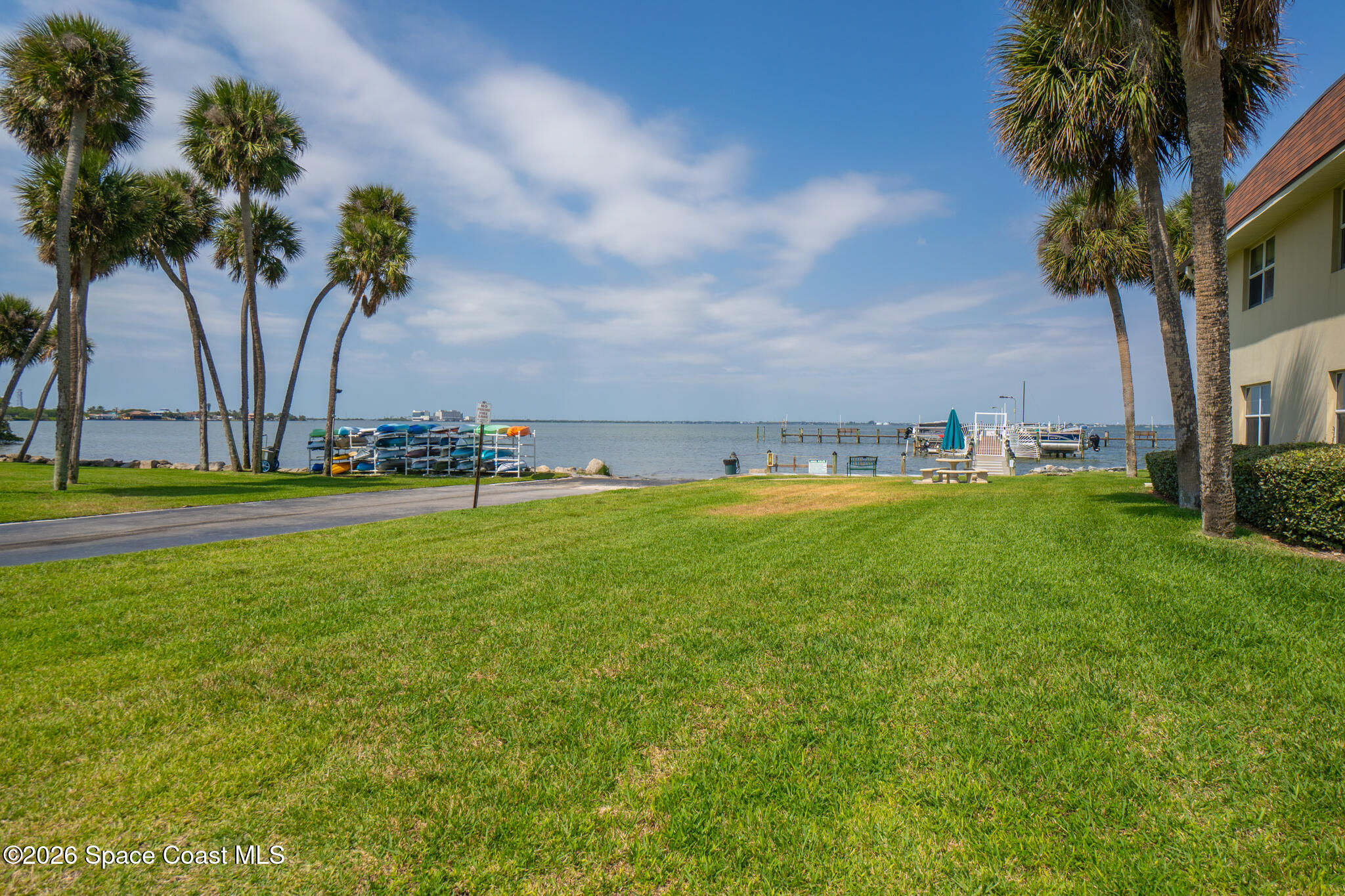 150 Intrepid Way, Unit 8D Cape Canaveral, FL 32920 - Photo 26 of 36 a view of yard with swimming pool and green space