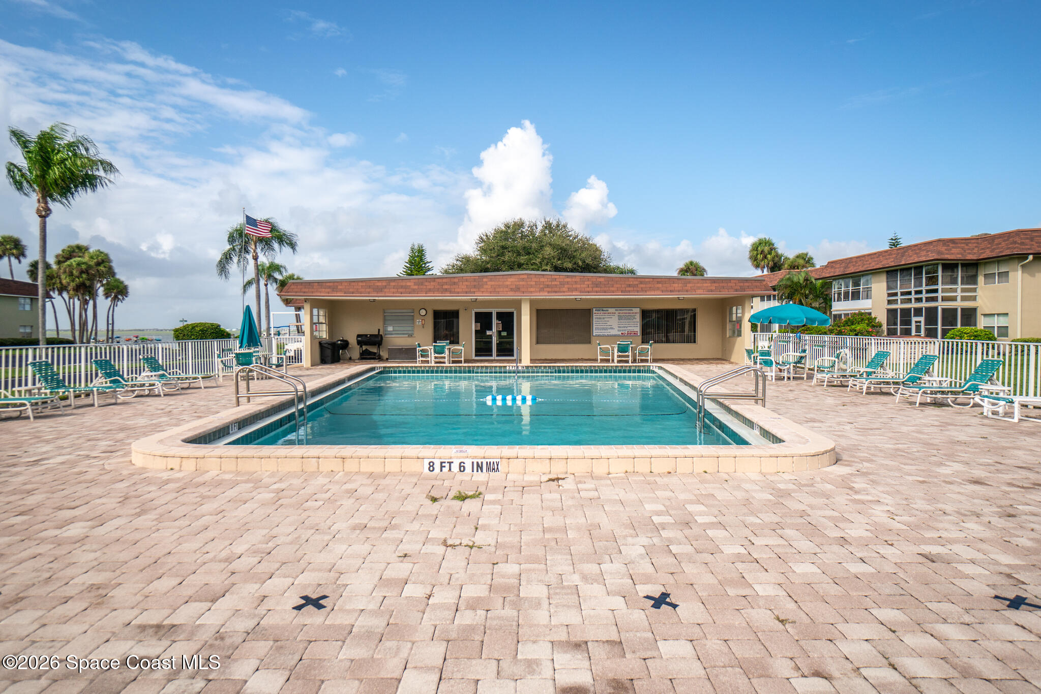 150 Intrepid Way, Unit 8D Cape Canaveral, FL 32920 - Photo 27 of 36 a view of swimming pool with outdoor seating and a garden