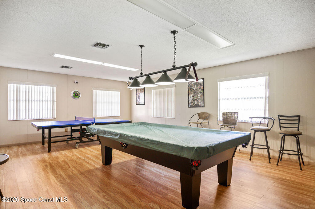 150 Intrepid Way, Unit 8D Cape Canaveral, FL 32920 - Photo 33 of 36 a room with pool table and windows