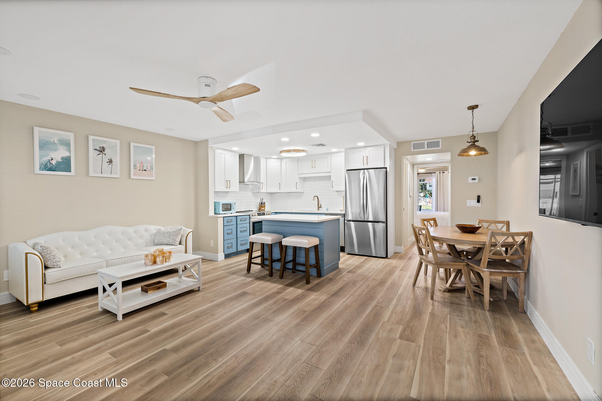 150 Intrepid Way, Unit 8D Cape Canaveral, FL 32920 - Photo 6 of 36 a living room with furniture and a dining table with kitchen view