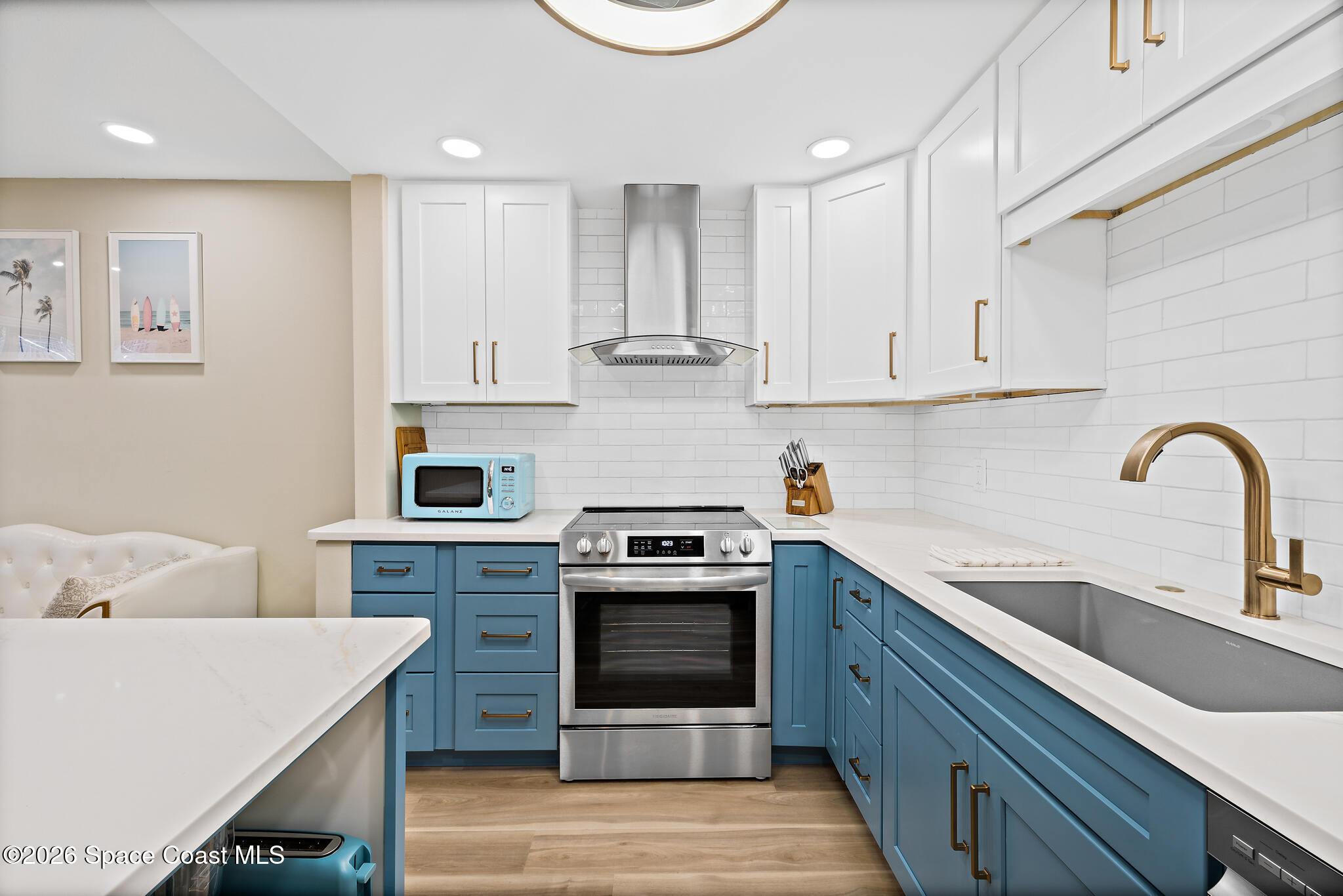 150 Intrepid Way, Unit 8D Cape Canaveral, FL 32920 - Photo 7 of 36 a kitchen with cabinets stainless steel appliances and a sink