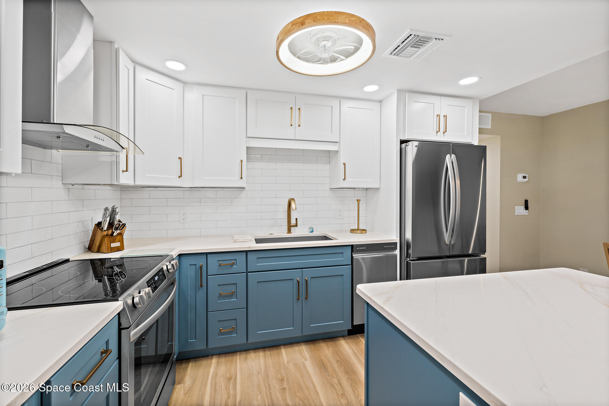 150 Intrepid Way, Unit 8D Cape Canaveral, FL 32920 - Photo 8 of 36 a kitchen with stainless steel appliances a sink a stove a refrigerator and cabinets