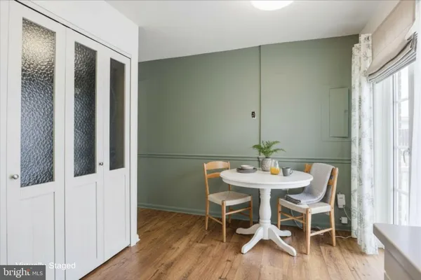a view of a dining room with furniture and wooden floor