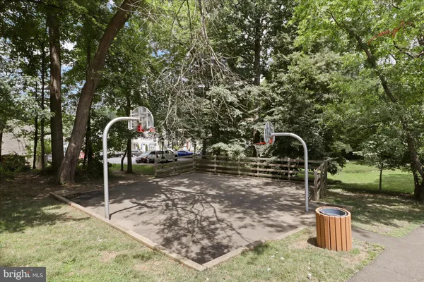 a view of tennis court with trees in the background
