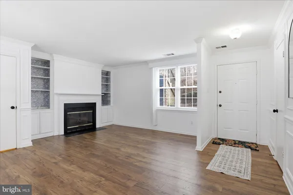 an empty room with windows and a fireplace