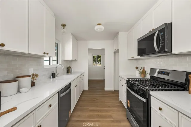 a kitchen with a stove microwave and sink