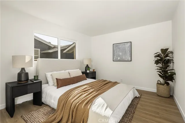 a bedroom with a bed and a lamp on table