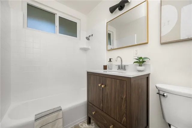 an empty room with wooden floor and window