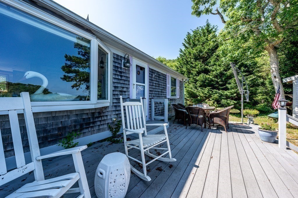 41 Aunt Debby's Road Dennis Port, MA 02639 - Photo 11 of 42 a balcony with wooden floor table and chairs