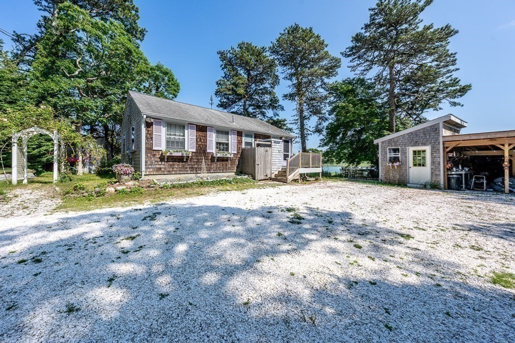 41 Aunt Debby's Road Dennis Port, MA 02639 - Photo 16 of 42 a view of a house with a yard covered with snow and trees