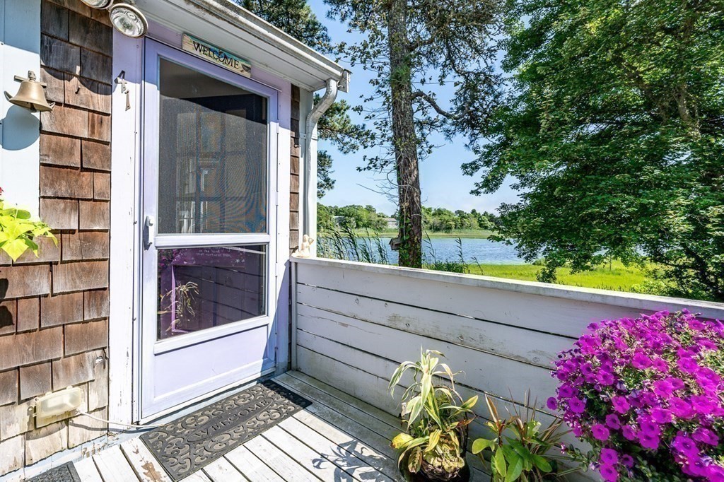 41 Aunt Debby's Road Dennis Port, MA 02639 - Photo 18 of 42 a vase of flowers sitting on a shelf
