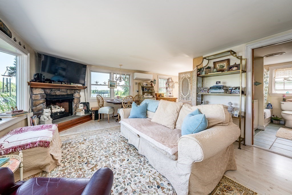 41 Aunt Debby's Road Dennis Port, MA 02639 - Photo 22 of 42 a living room with furniture large window and a fireplace