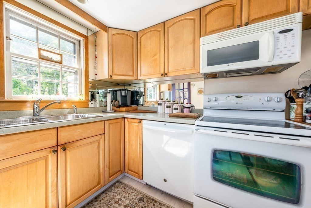 41 Aunt Debby's Road Dennis Port, MA 02639 - Photo 26 of 42 a kitchen with stainless steel appliances granite countertop a sink a stove and cabinets