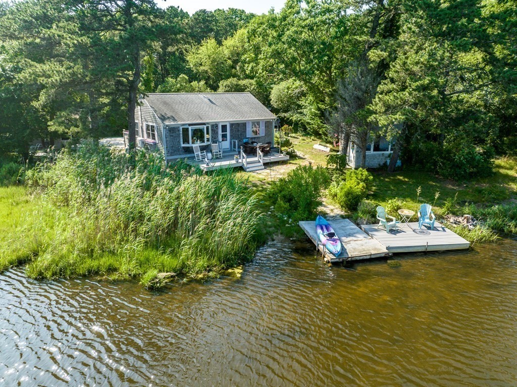 41 Aunt Debby's Road Dennis Port, MA 02639 - Photo 5 of 42 a view of a swimming pool with lawn chairs and plants