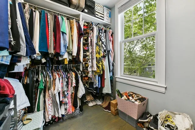 a view of walk in closet with clothes