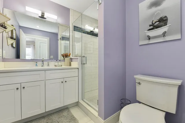 a bathroom with a toilet a sink and mirror