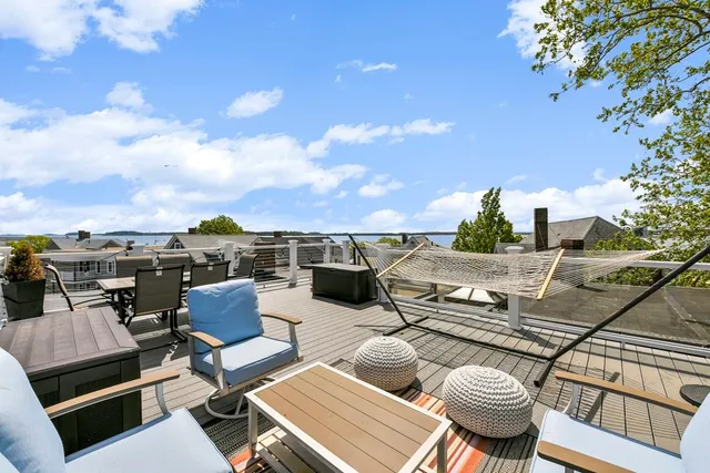 a view of swimming pool with outdoor seating and city view