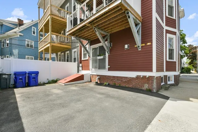 a front view of a residential apartment building with a yard