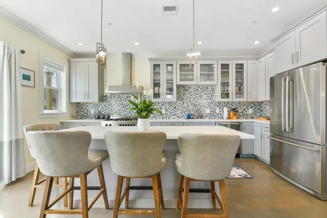a large kitchen with a table and chairs