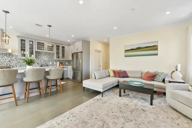 a living room with furniture and a chandelier