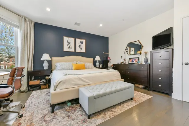 a bed room with a bed and a tv