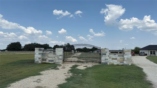 a view of a fountain in middle of a yard