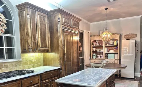 a kitchen with stainless steel appliances granite countertop a stove and a refrigerator